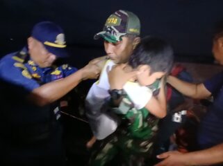 Seorang Prajurit TNI AL, saat mengecvakuasi anak kecil korban terbakarnya KM Barcelona  (Foto : Puspenk TNI )