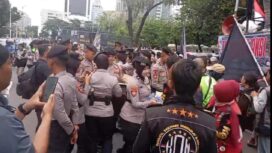 Aksi Polwan Polda Metro Jaya saat membegikan air kemasan kepada para peserta demo Ojol. (Foto : Humas Polda Metro Jaya)