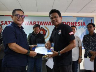 Sekretaris Umum PWI Jaya, Arman Suparman saat menyerahkan Piagan OKK dan Kartu Anggota Kepada peserta OKK. (Foto : PWI Jaya)