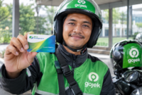 Pengemudi ojek online sedang memperlihatkan kartu BPJS Ketenagakerjaan. (Foto: Ilustrasi)